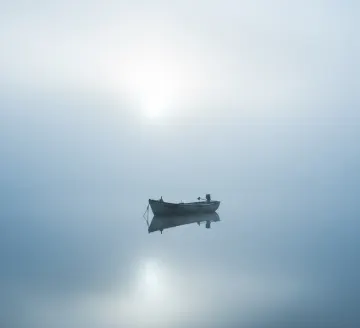 foggy-morning-rowboat-calm-water